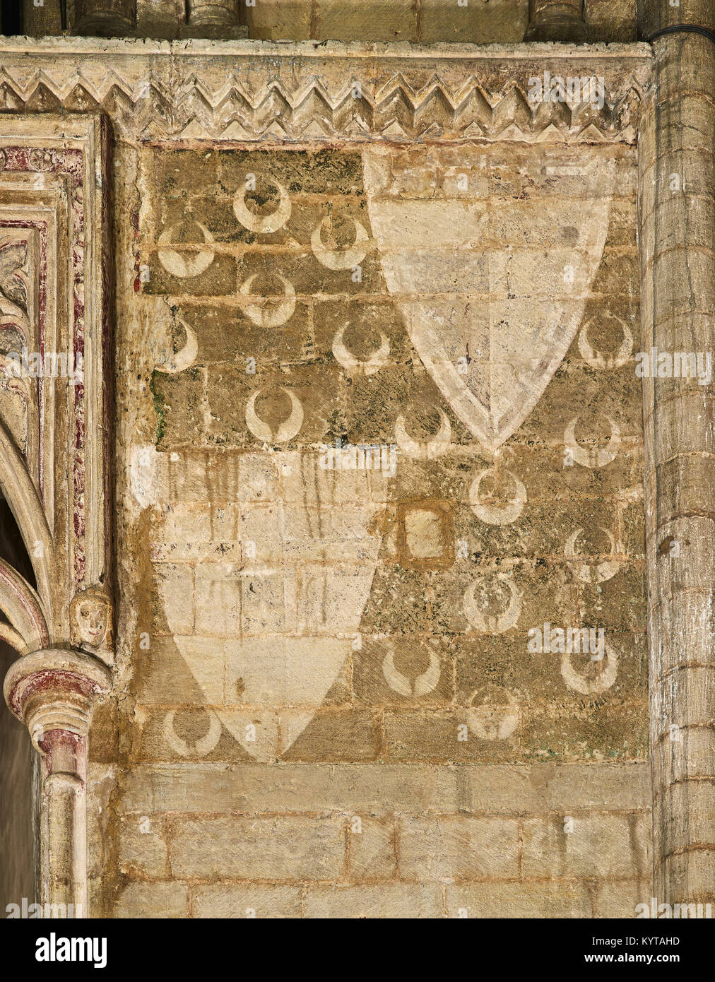 Peterborough Cathedral. Remains of wall-paintings in the apse showing shields and crescent moons. Stock Photo