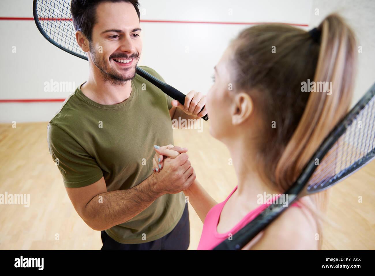 Man and woman shaking hands before squash game Stock Photo Alamy