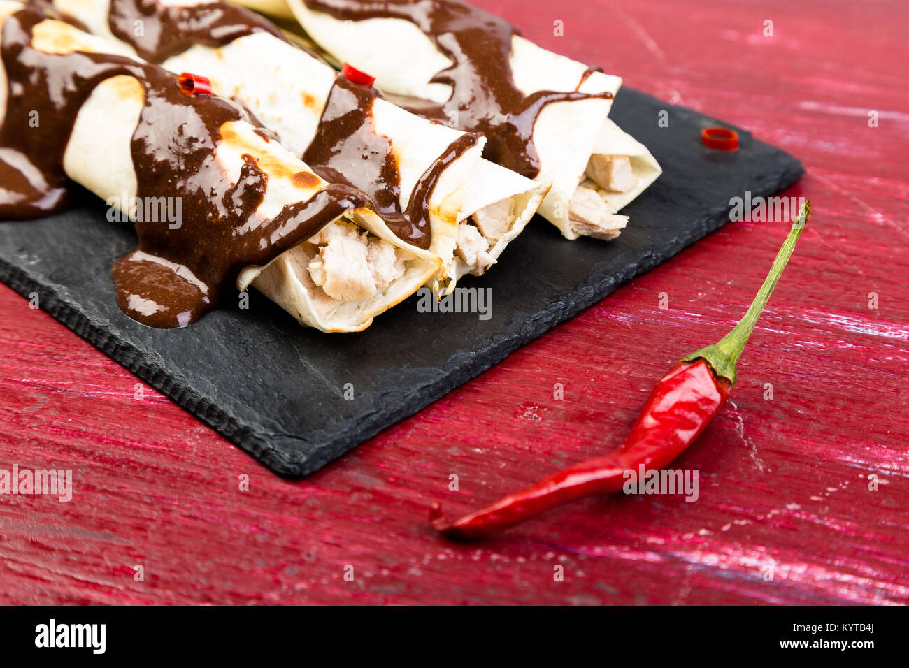 Mexican chicken enchiladas with chili chocolate salsa mole poblano