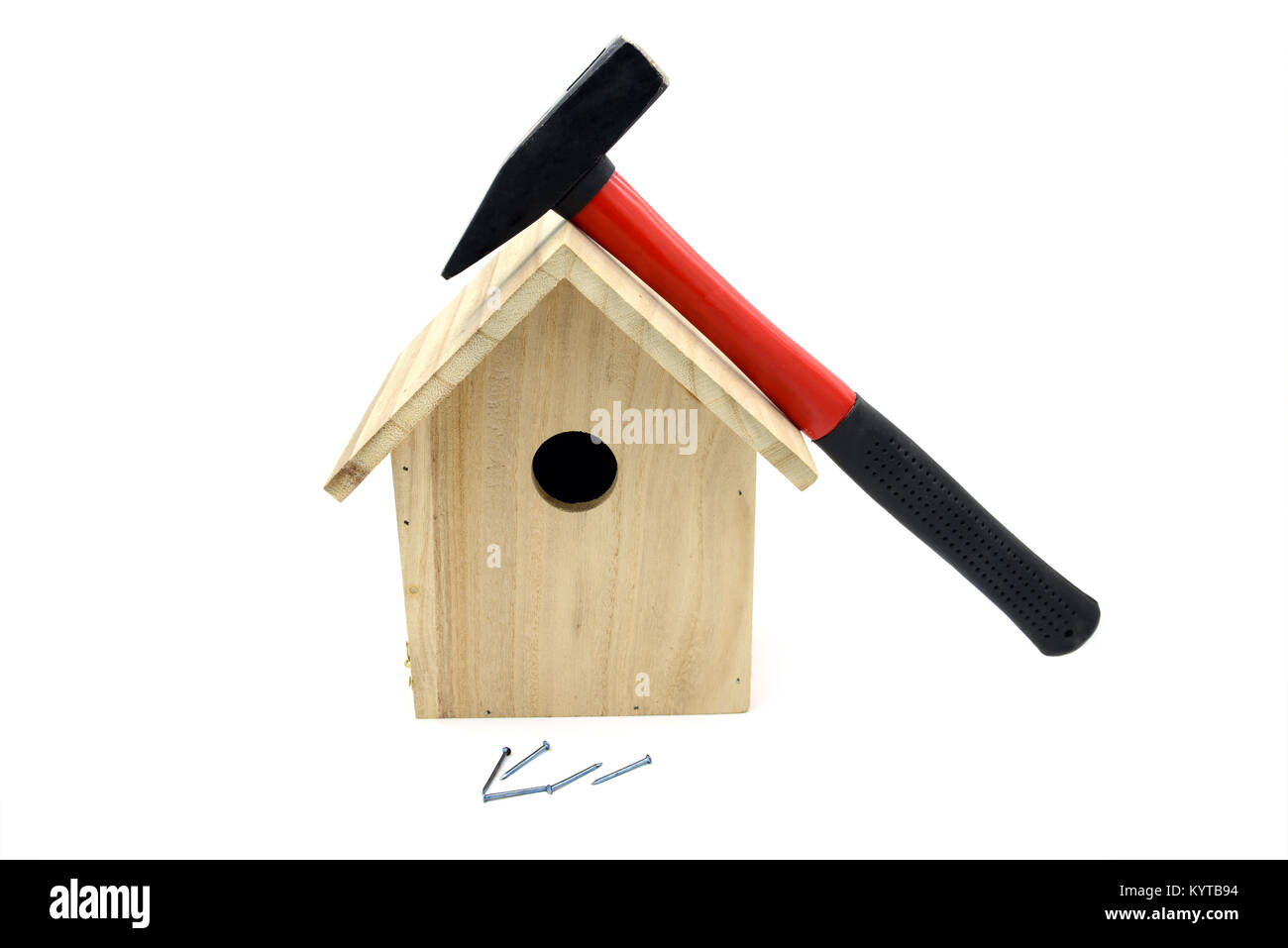 building bird nesting box with hammer, nails. white isolated background Stock Photo