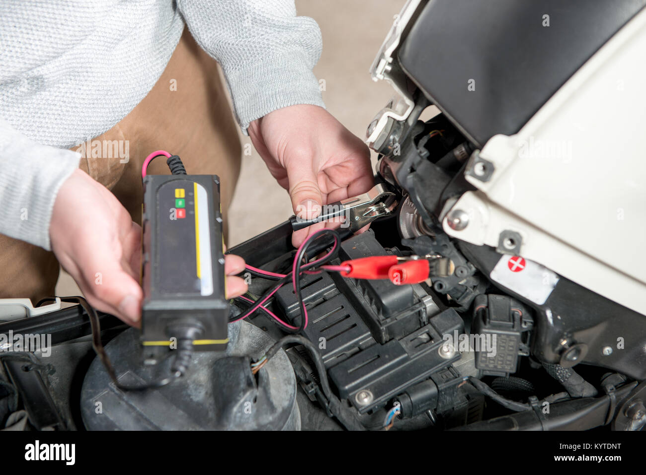 charging the battery of the motorcycle Stock Photo Alamy