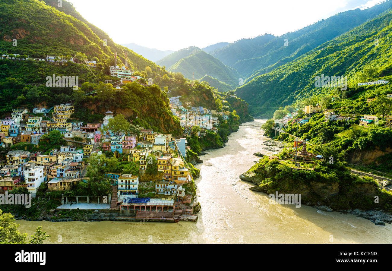 Confluence of two rivers Alaknanda and Bhagirathi give rise to the holy river of Ganga / Ganges at one of the five Prayags called Dev Prayag. Greenery Stock Photo