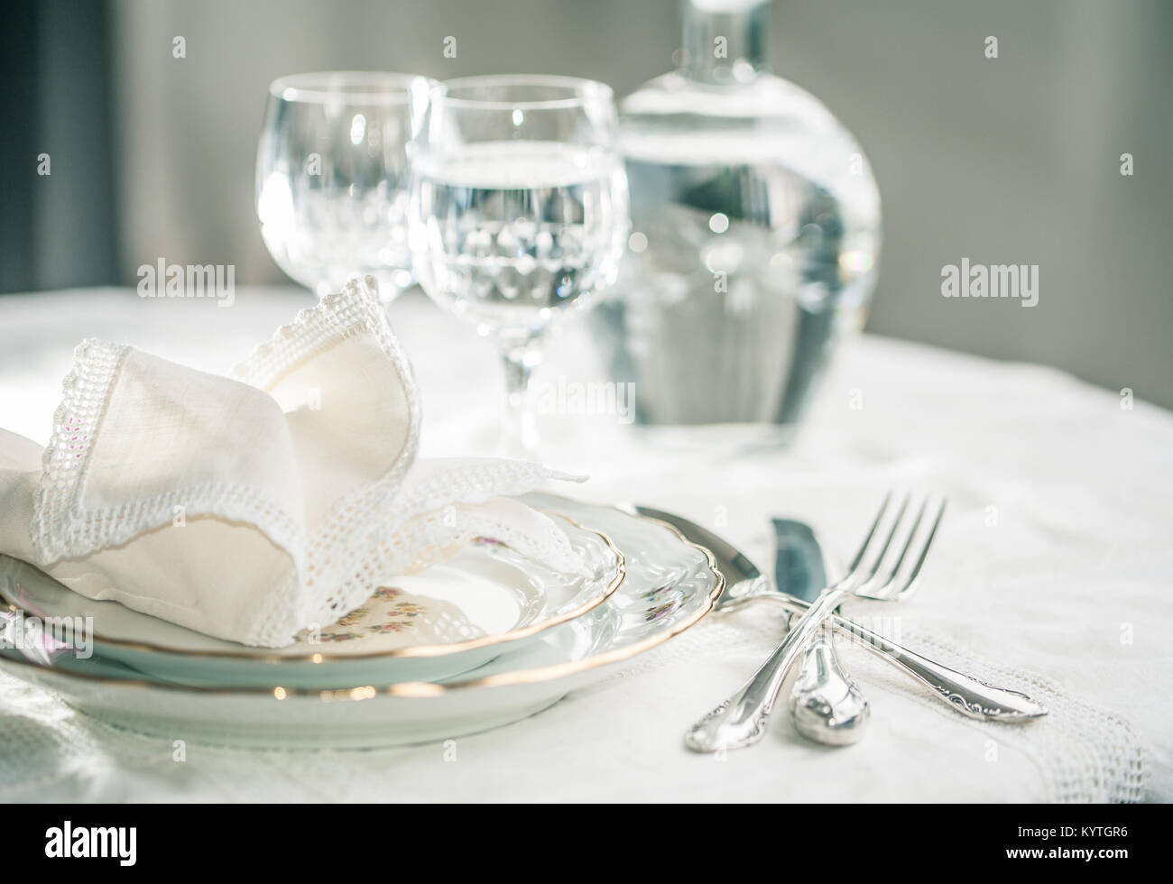 Luxury dinner set with silverware, elegant porcelain dishes, crystal