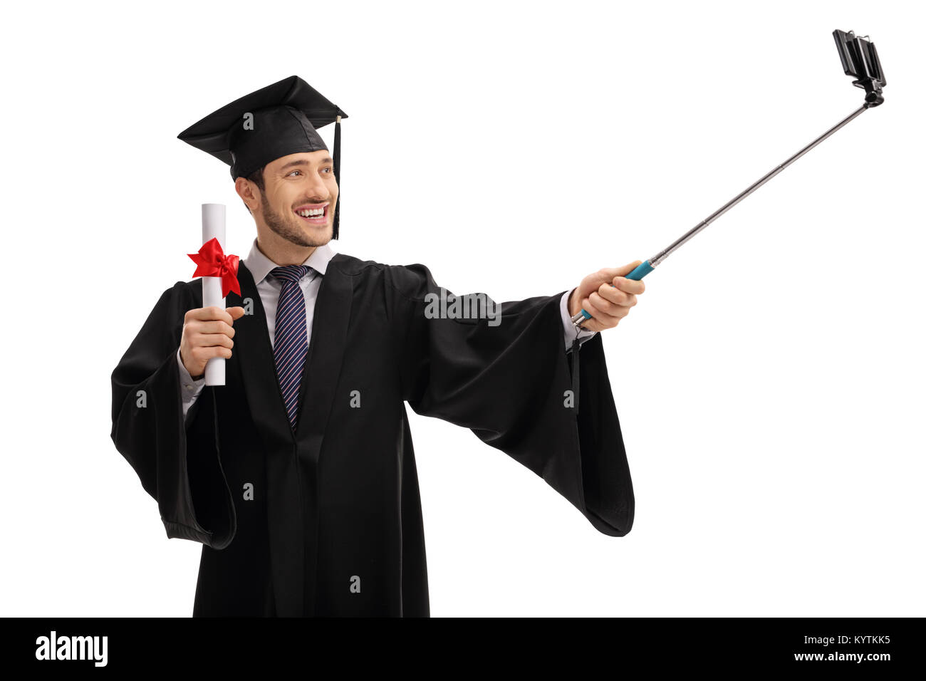 Graduate student holding a diploma and taking a selfie with a stick ...