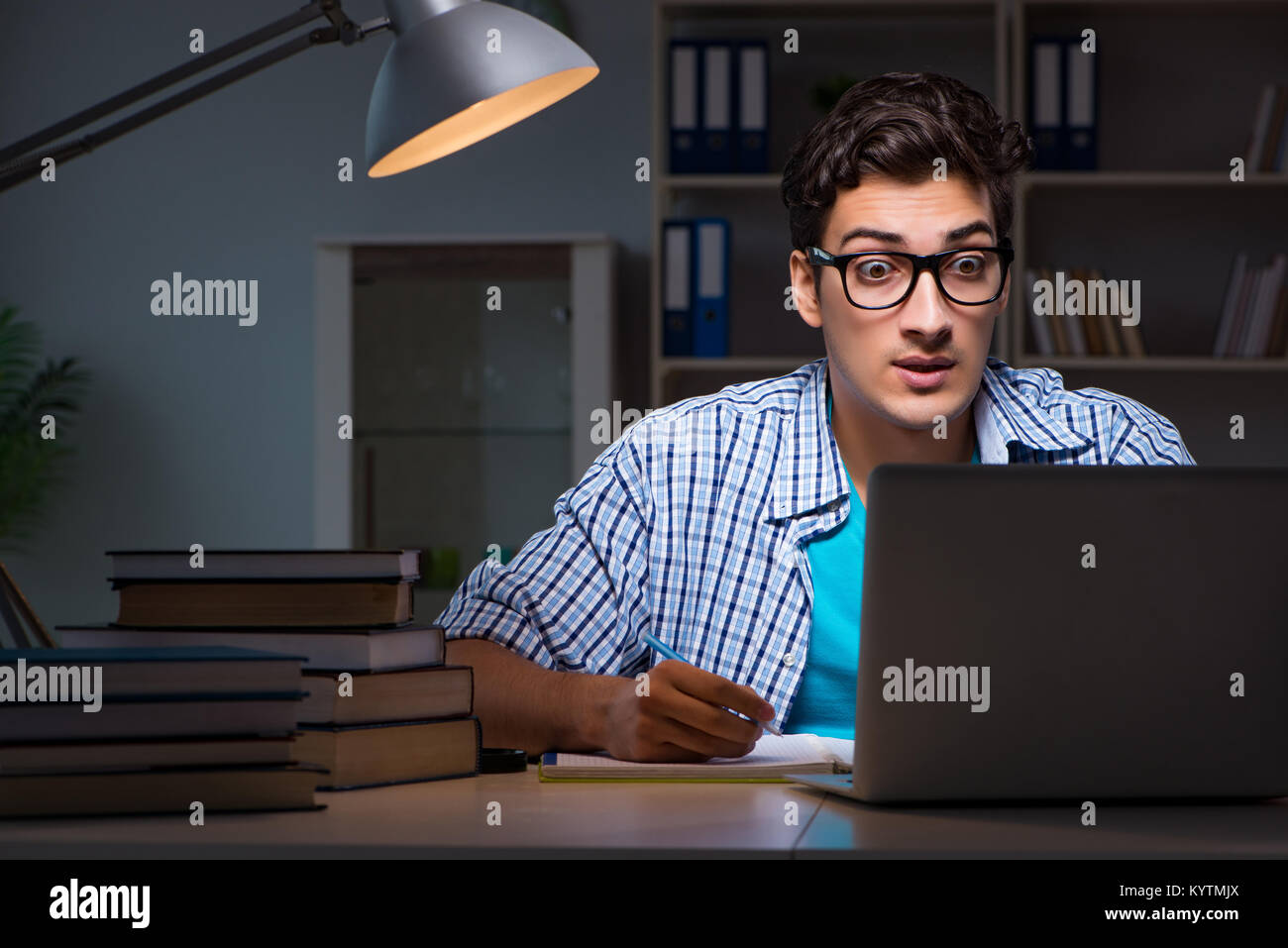 Student preparing for exams late night at home Stock Photo - Alamy