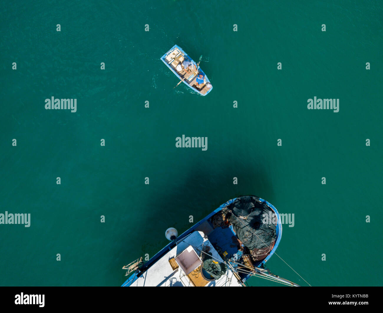 Aerial view of a Man in a boat rowing among the boats moored in a harbor. Vibo Marina. Calabria, Italy Stock Photo