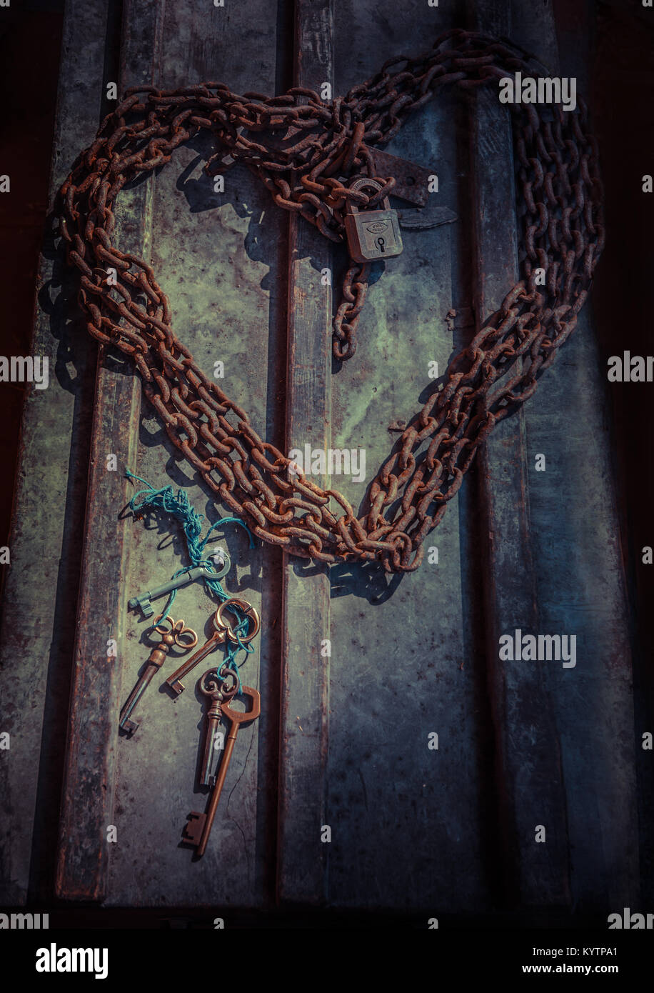 Heart made of rusty chains , with several keys Stock Photo