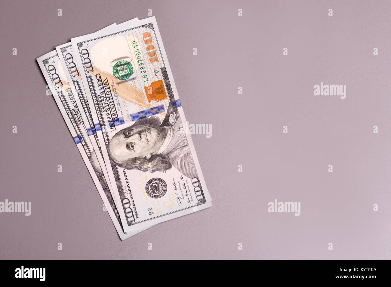 Three banknotes lying on a gray background Stock Photo - Alamy
