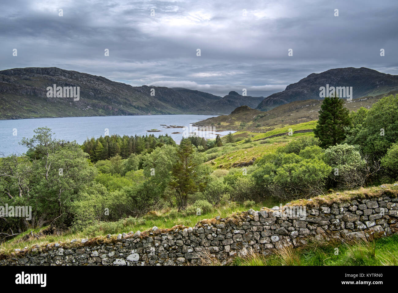 Old dry stone wall and Loch Glencoul near Unapool and Gleann Dubh, Kylesku, Sutherland in the Highlands of Scotland, UK Stock Photo