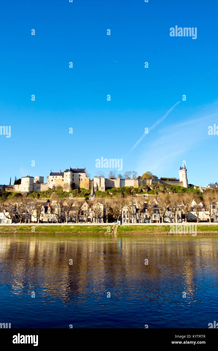 Chinon town with its chateau on the hill above in spring afternoon sunshine on the banks of the River Vienne, Indre-et-Loire, France Stock Photo