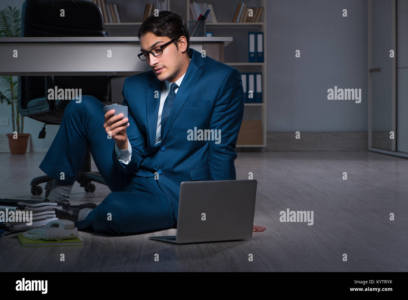 Businessman working overtime long hours late in office Stock Photo - Alamy