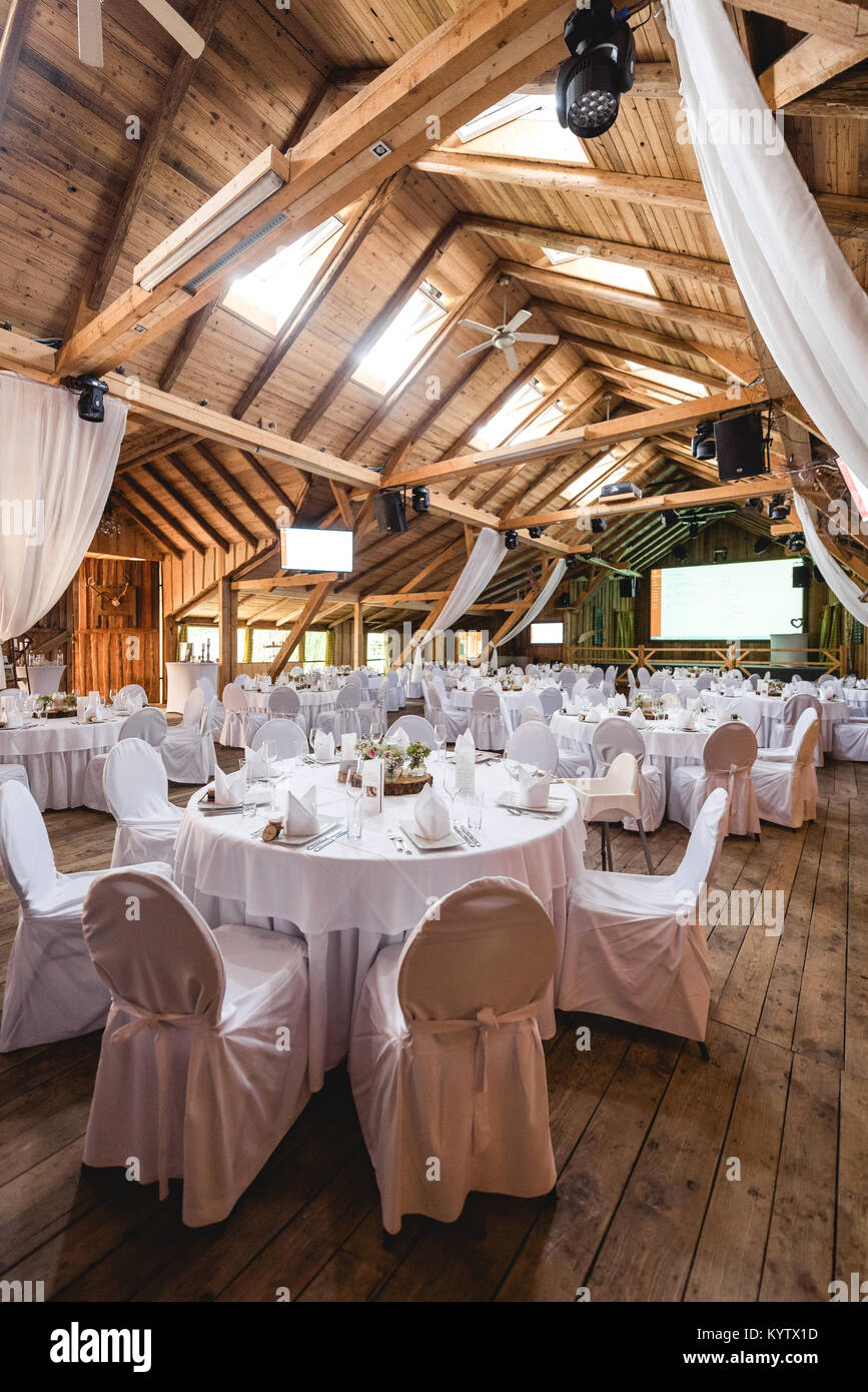 Rustical wedding banquet hall with white decoration Stock Photo - Alamy