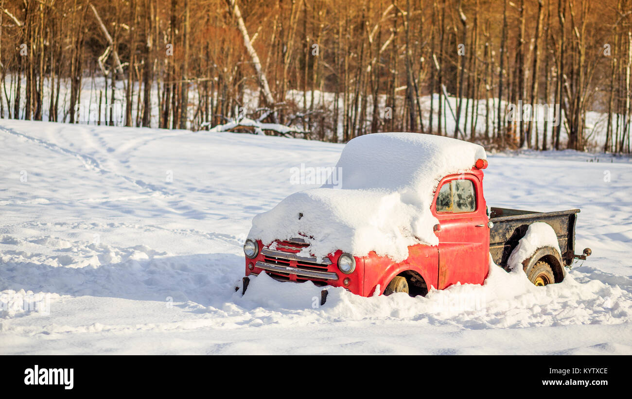 Old Dodge farm truck in the snow on a farm in Etna, New Hampshire in