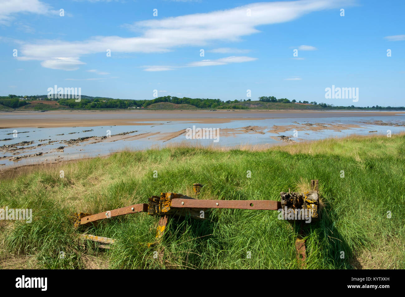 Obsolete small boats and barges were stranded on the banks of the tidal River Severn in Gloucestershire, UK to protect the river banks from erosion. Now they form an atmospheric local attraction to sightseers. Stock Photo