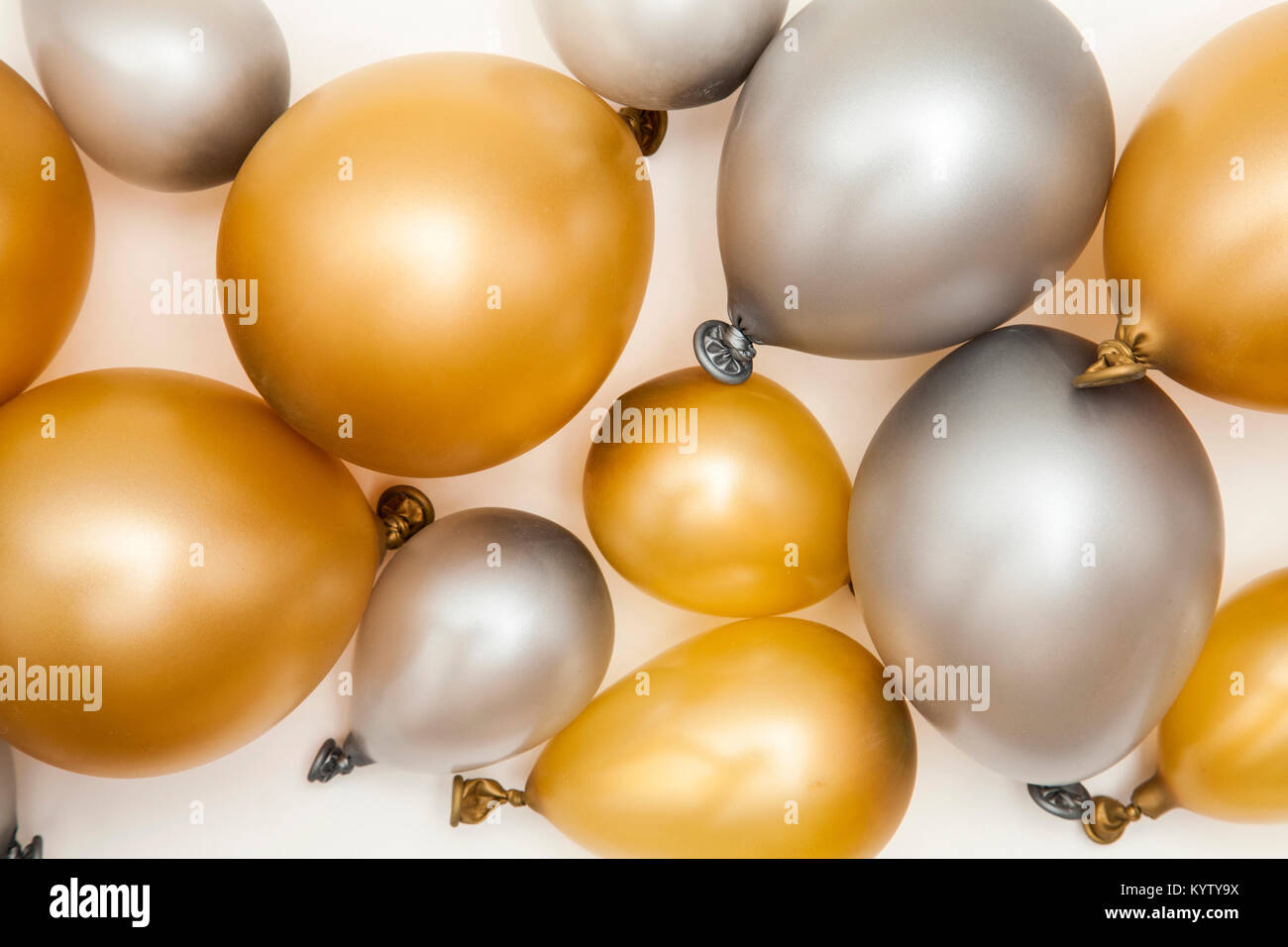 Gold and silver party celebration balloons on a plain background Stock Photo