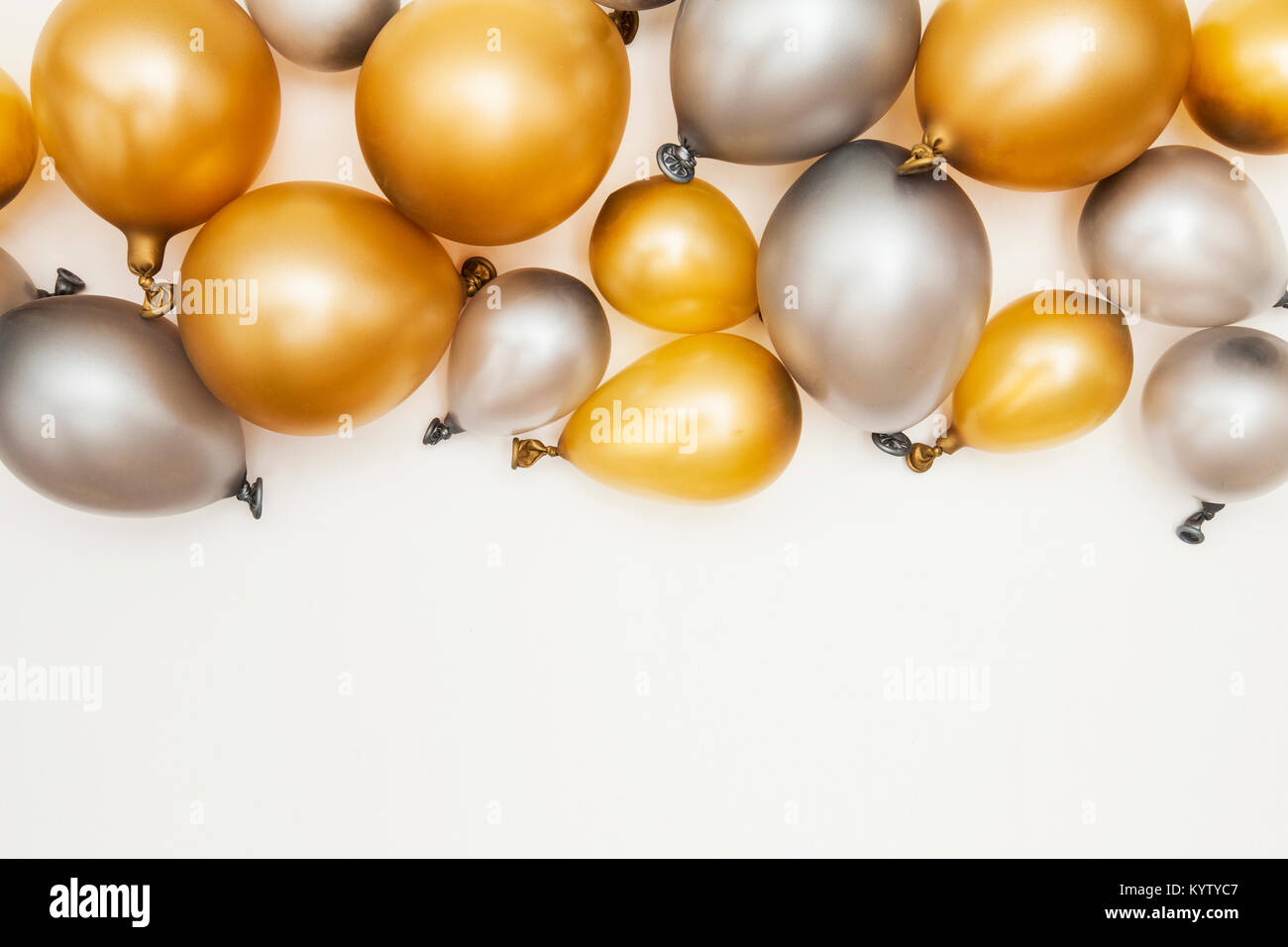 Gold and silver party celebration balloons on a plain background Stock Photo