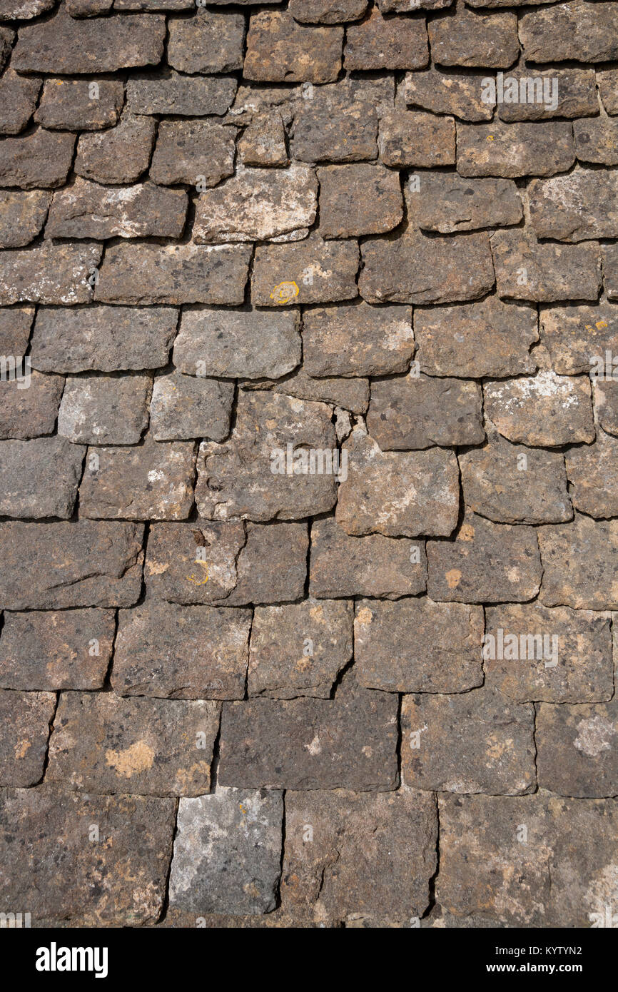 Old limestone roof tiles background. Construction full frame texture