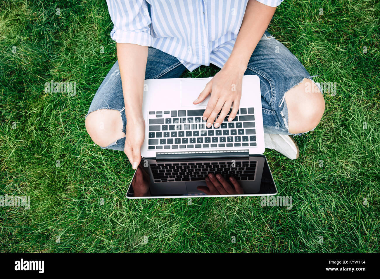 Cropped shot of young woman using laptop with blank screen while ...