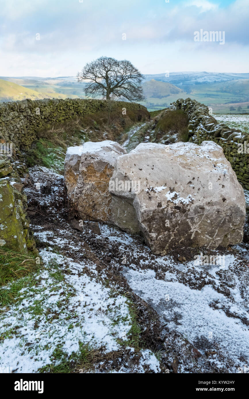 Large pieces of stone blocking a bridleway near Hollinsclough to prevent illegal traffic inc 4x4's from using it. Peak District National Park Stock Photo