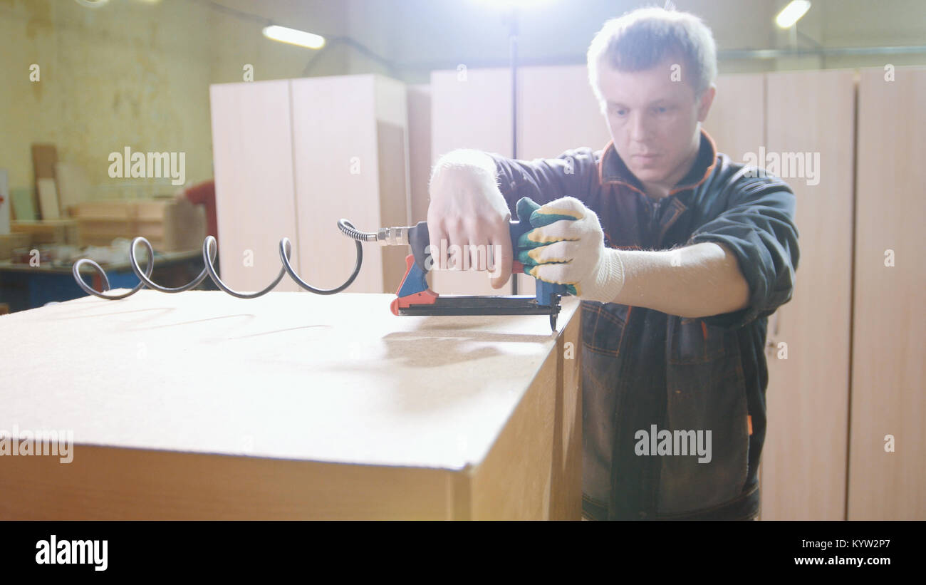 Carpenter working electric industrial stapler hi-res stock photography ...