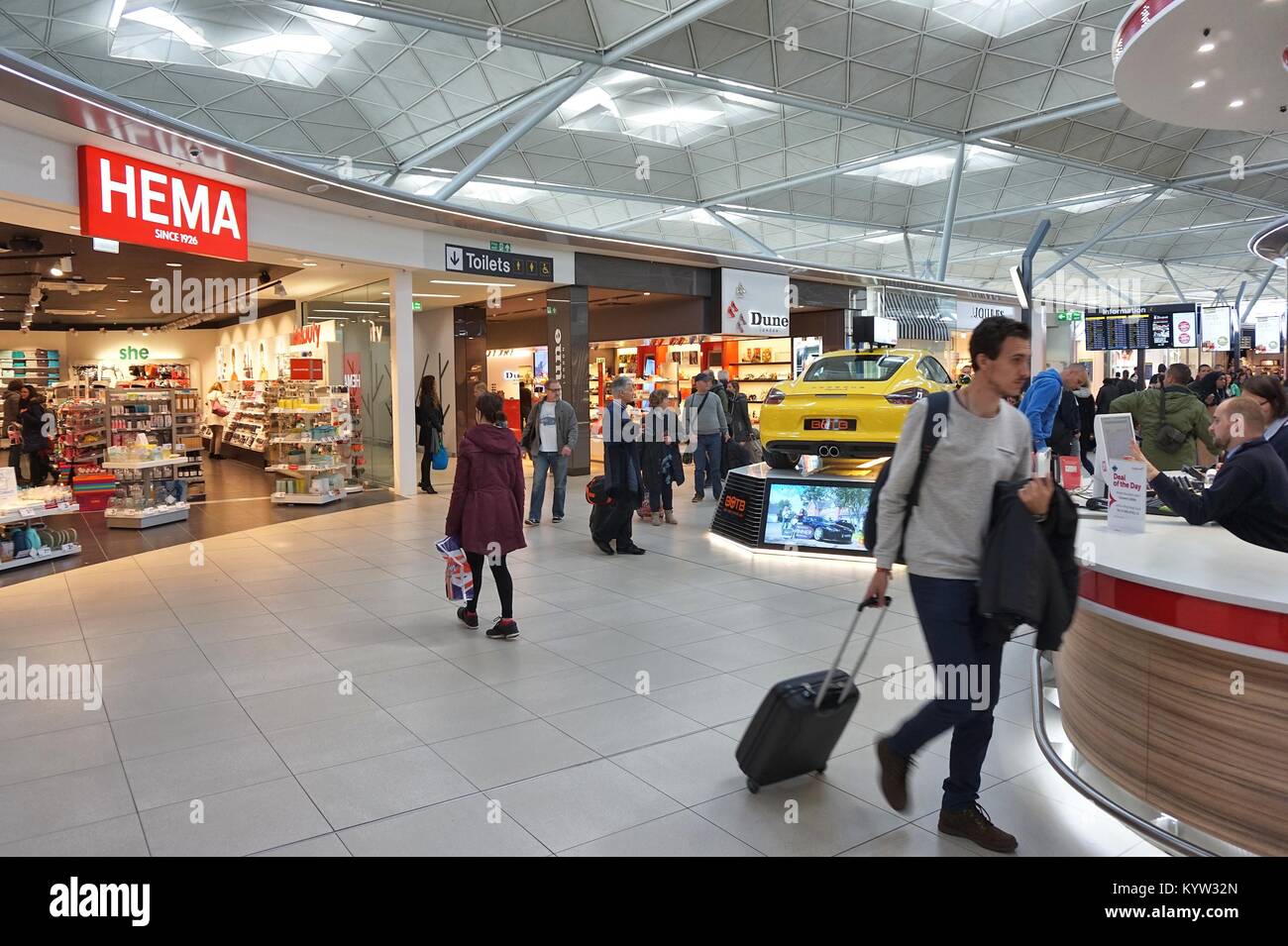 LONDON, UK - APRIL 24, 2016: People visit duty free shops in London Stansted Airport, UK. With 22.5 million passengers in 2015 Stansted was the 4th bu Stock Photo