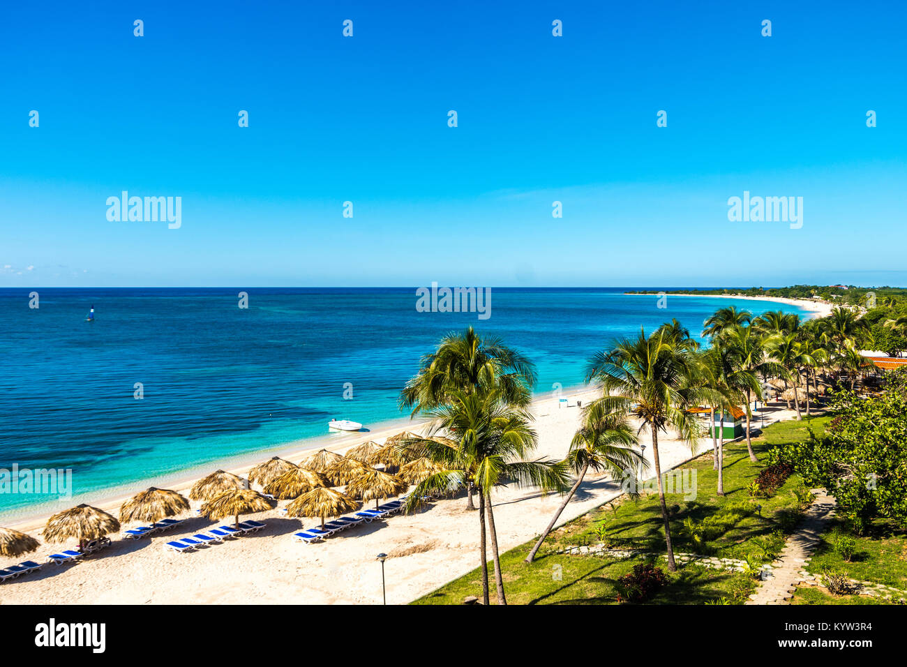 Amazing view of a paradisiac beach in Playa Ancon, palm trees, translucent blue water, straw umbrellas, sun. Stock Photo