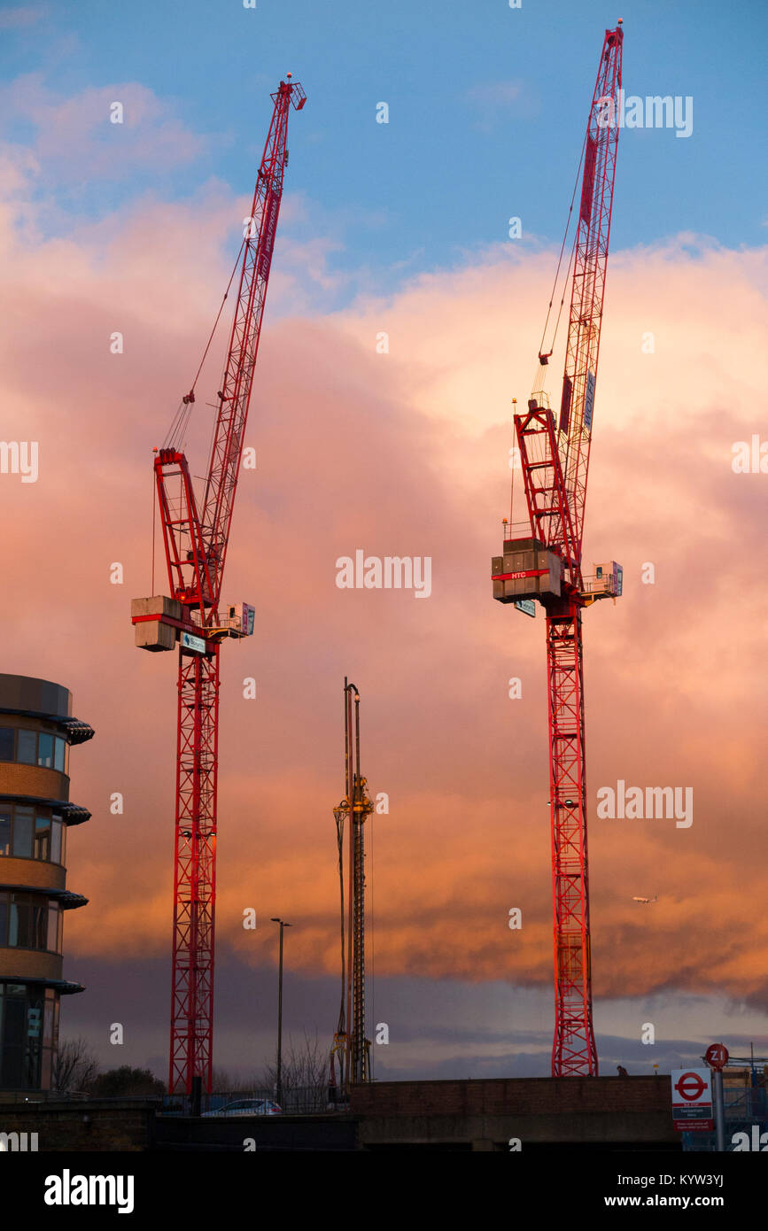 Construction site with 2 / two luffing jib tower cranes at rest from