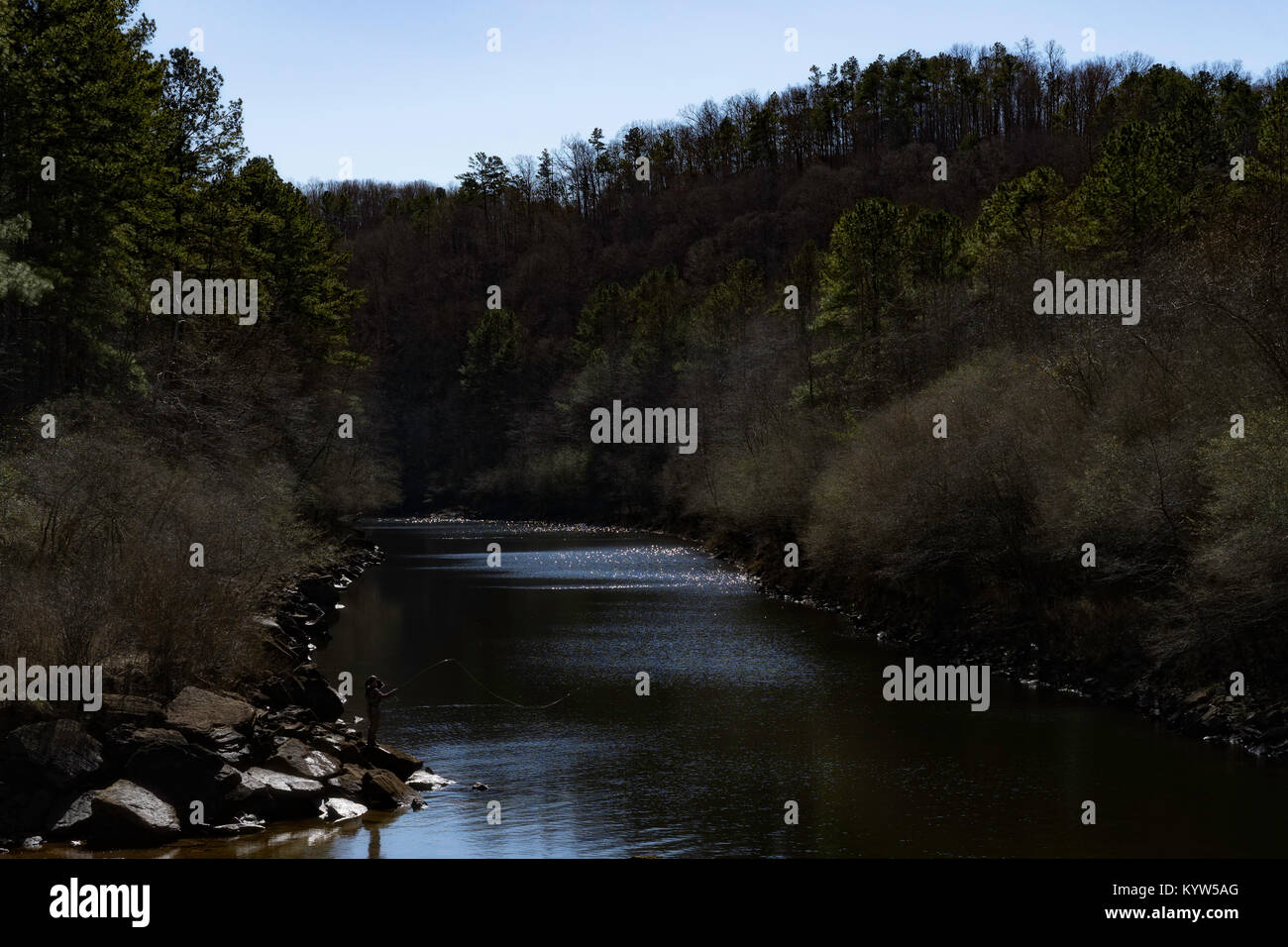 An angler enjoys a little sunshine while fly fishing for trout on the Sipsey Fork near Jasper, Alabama. Stock Photo