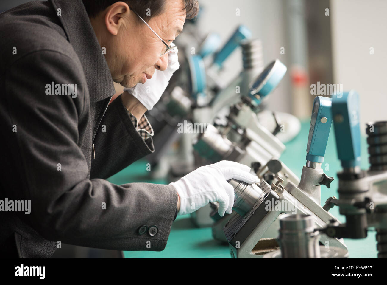 Rui'an, China's Zhejiang Province. 16th Jan, 2018. An engineer from Rui'an Hsoar Group checks a component of robots in Rui'an City, east China's Zhejiang Province, Jan. 16, 2018. Over 30 enterprises in Rui'an City purchased more than 500 robots to boost productivity. Credit: Weng Xinyang/Xinhua/Alamy Live News Stock Photo