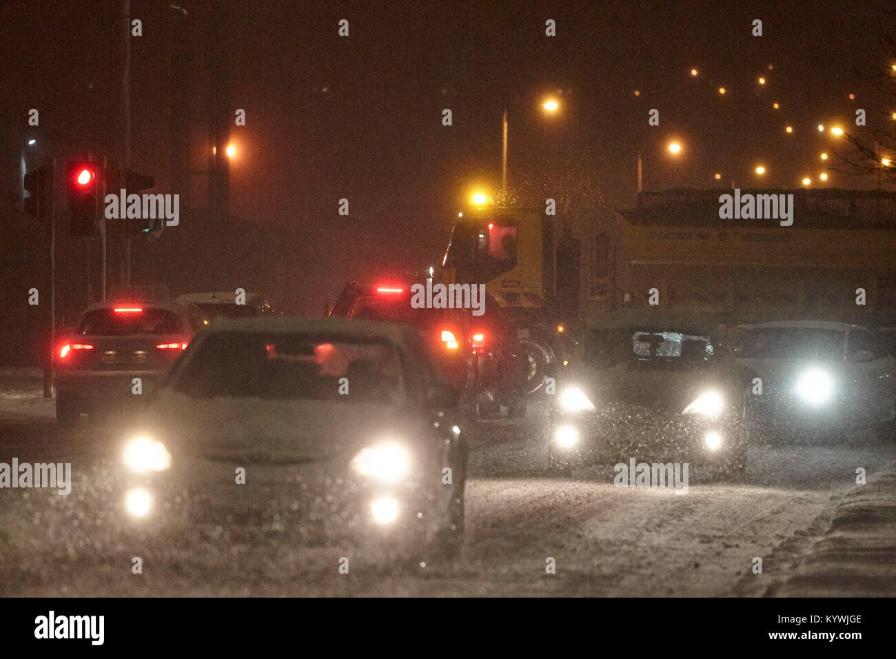 Newtownabbey, Northern, Ireland. 16th Jan, 2018. Gritter lorries attempt to clear roads during amber weather warning as heavy snowfall starts to cover Newtownabbey outside Belfast, Northern Ireland, 16th January 2018 Credit: Radharc Images/Alamy Live News Stock Photo