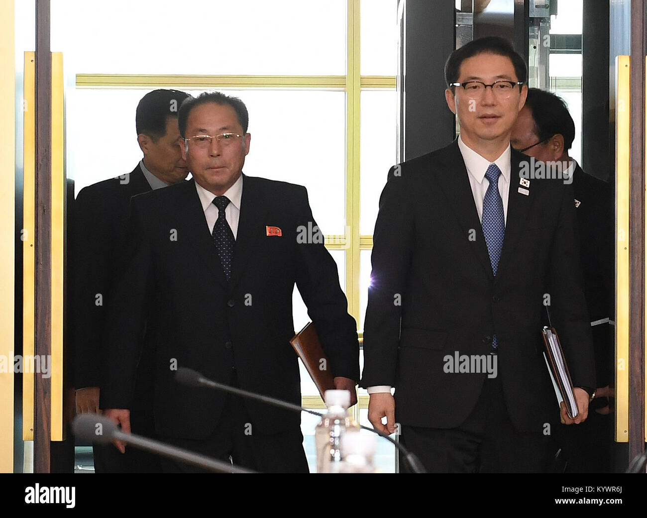 (180117) -- SEOUL, Jan. 17, 2018 (Xinhua) -- Chun Hae-sung(R), vice unification minister of South Korea, and Jon Jong Su, vice chairman of the Committee for the Peaceful Reunification of the Fatherland of the Democratic People's Republic of Korea (DPRK), arrive for talks at the truce village of Panmunjom, Jan. 17, 2018. Working-level talks between South Korea and DPRK were underway Wednesday at the truce village of Panmunjom to discuss the DPRK's dispatch of athletes to the South Korea-hosted Winter Olympics, Seoul's Unification Ministry said. (Xinhua/South Korean Unification Ministry) (psw) Stock Photo