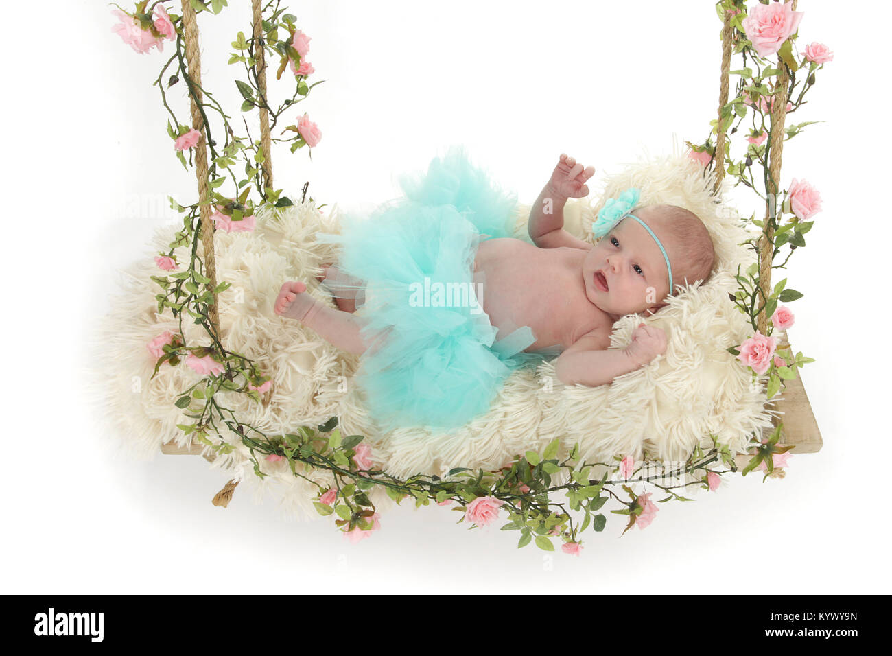 3 week old baby girl in too-too on beautiful flower swing Stock Photo