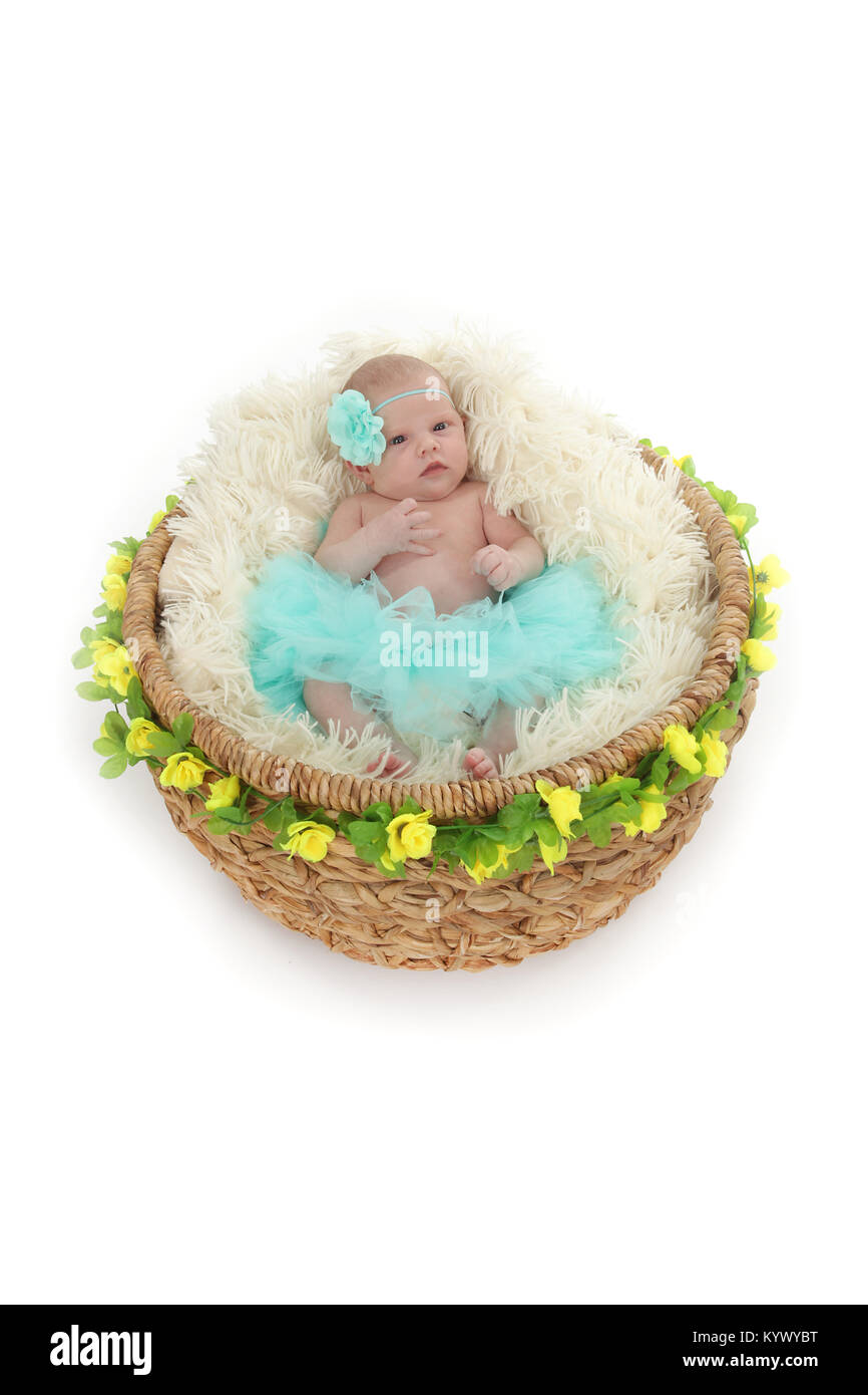 3 week old baby girl in too-too on beautiful flower basket Stock Photo