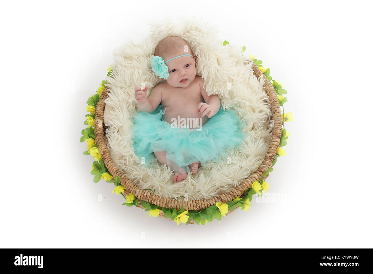 3 week old baby girl in too-too on beautiful flower basket Stock Photo