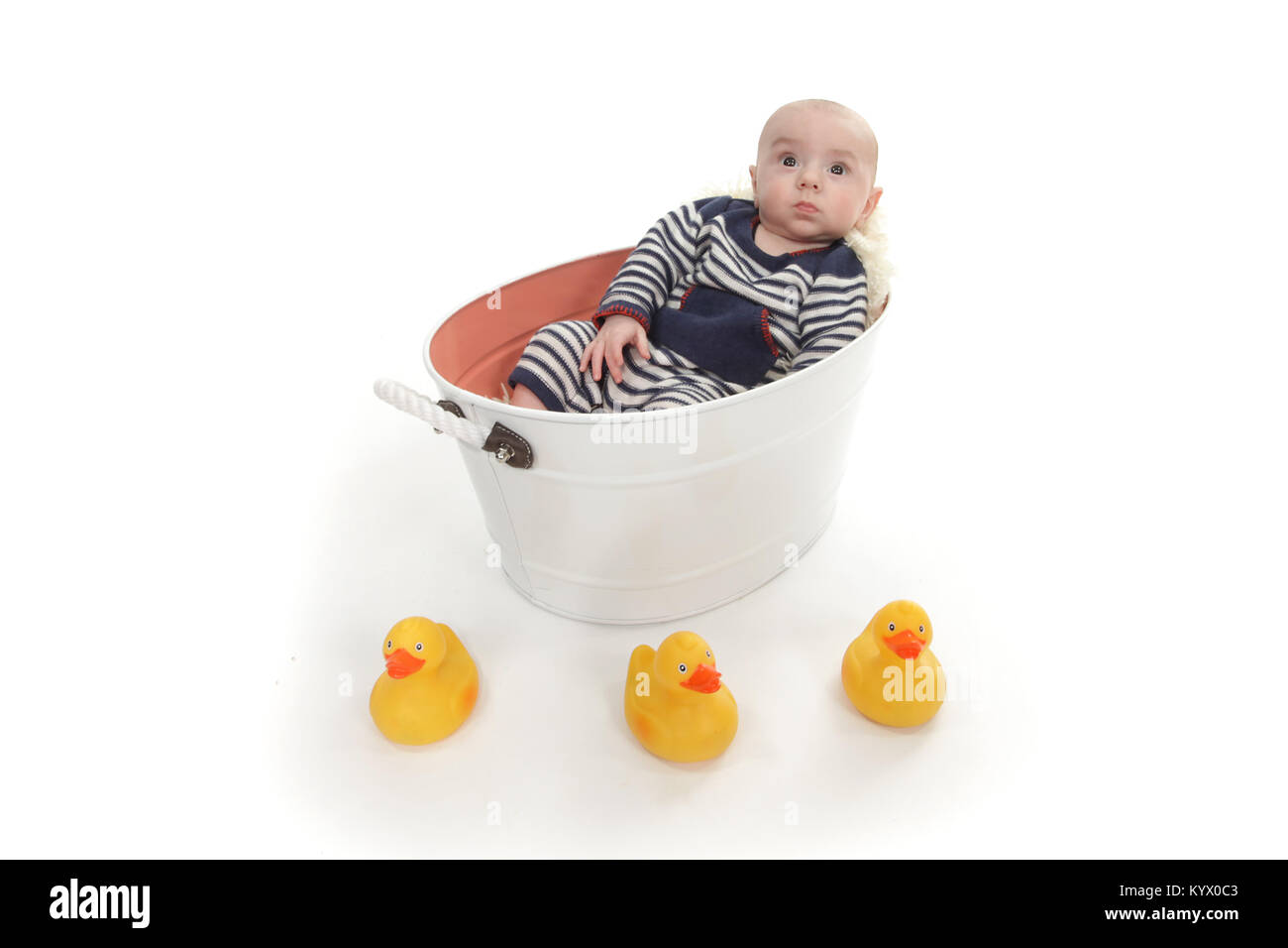12 week old baby boy exploring in tin bath tub with rubber ducks Stock Photo Alamy