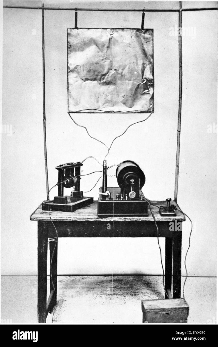 Marconi's first transmitter incorporating a monopole antenna. It consisted of an elevated copper sheet (top) connected to a Righi spark gap (left) powered by an induction coil (center) with a telegraph key (right) to switch it on and off to spell out text messages in Morse code. Stock Photo