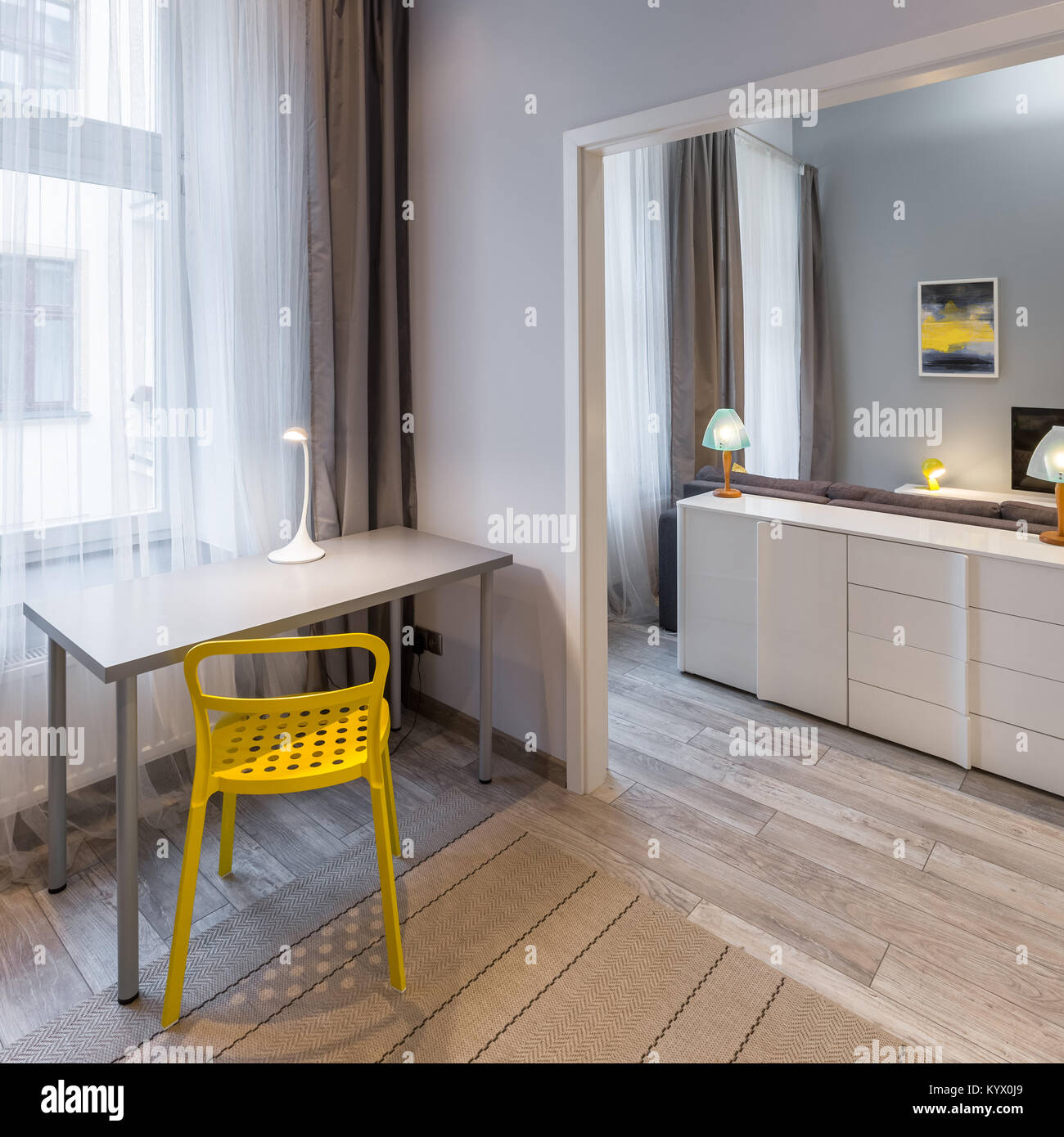 Home office interior with yellow chair and simple desk Stock Photo - Alamy