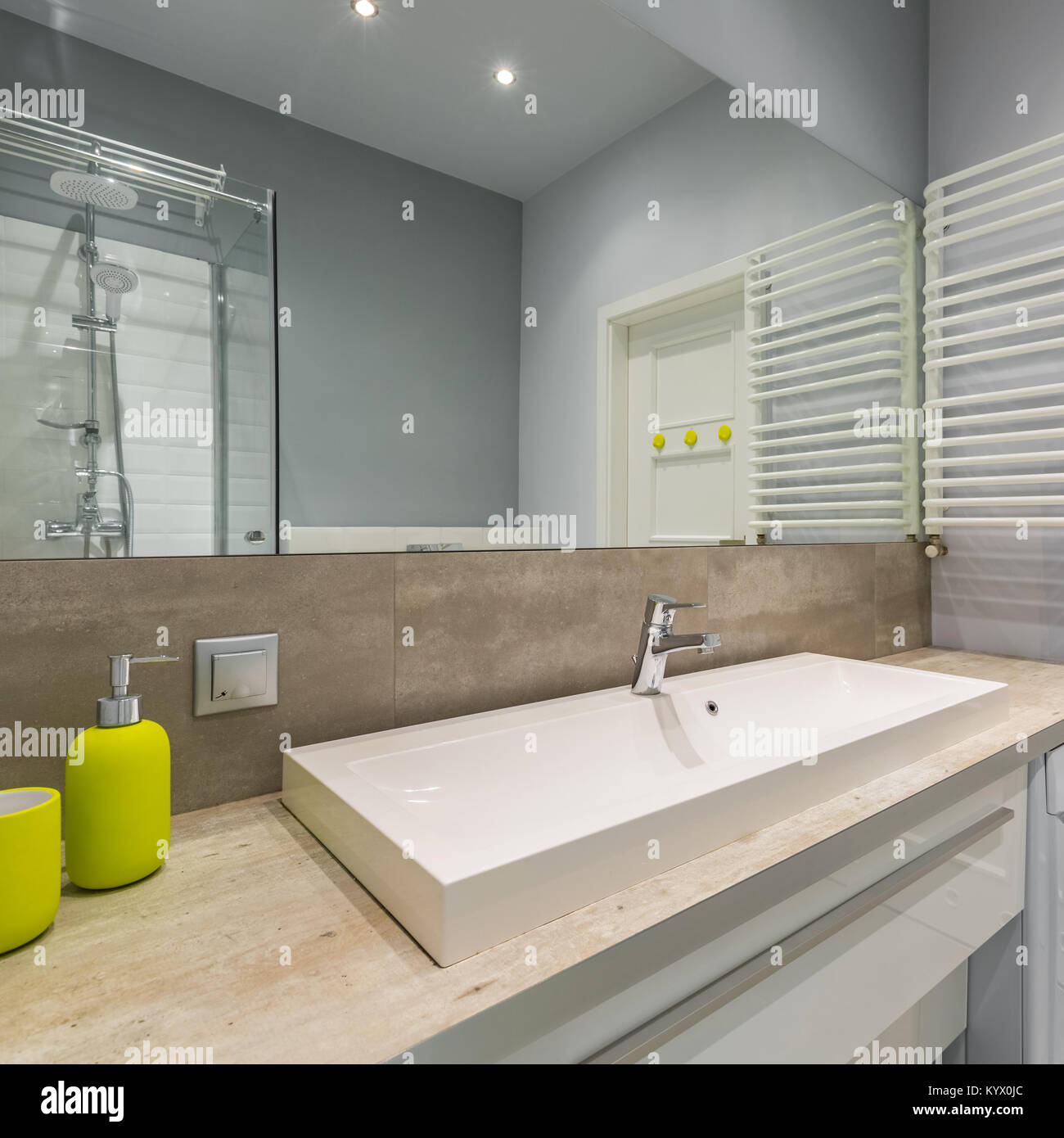 Beautiful bathroom with big mirror, elegant basin and shower Stock Photo