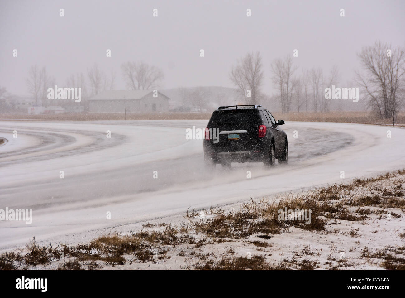 Vehicles traveling on slippery icy road in snow storm Stock Photo - Alamy