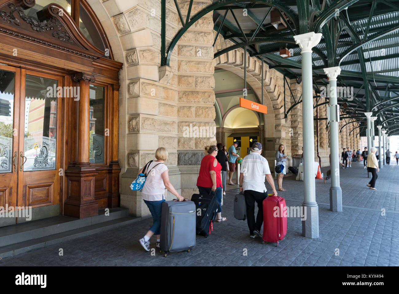 People with suitcases and luggage at the entrance to Central Station, Sydney, Australia Stock Photo