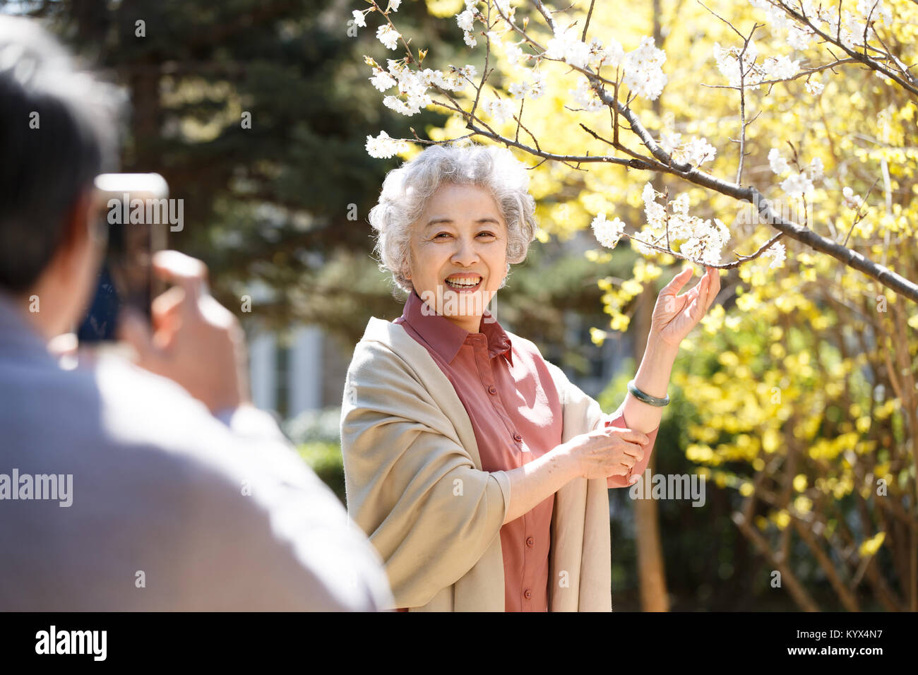 The husband is taking pictures of his wife Stock Photo - Alamy