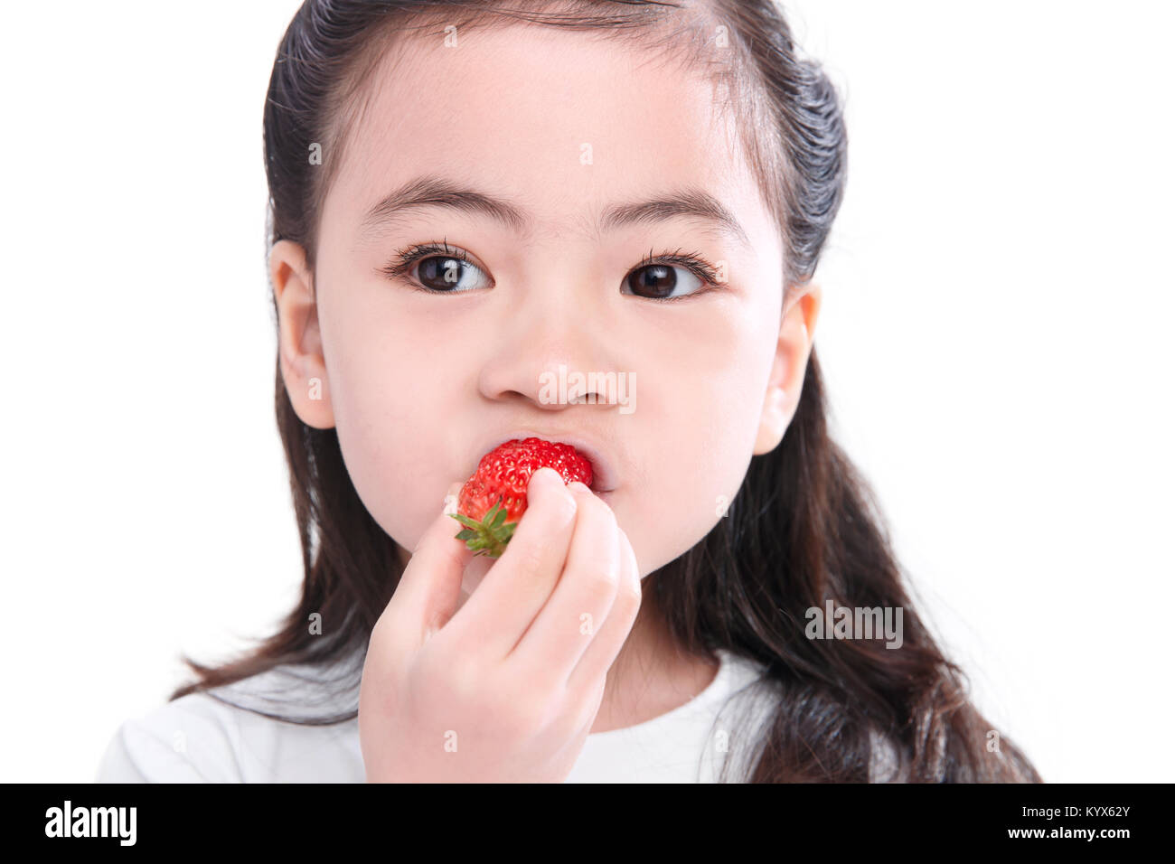 The cute little girl eats strawberries Stock Photo Alamy