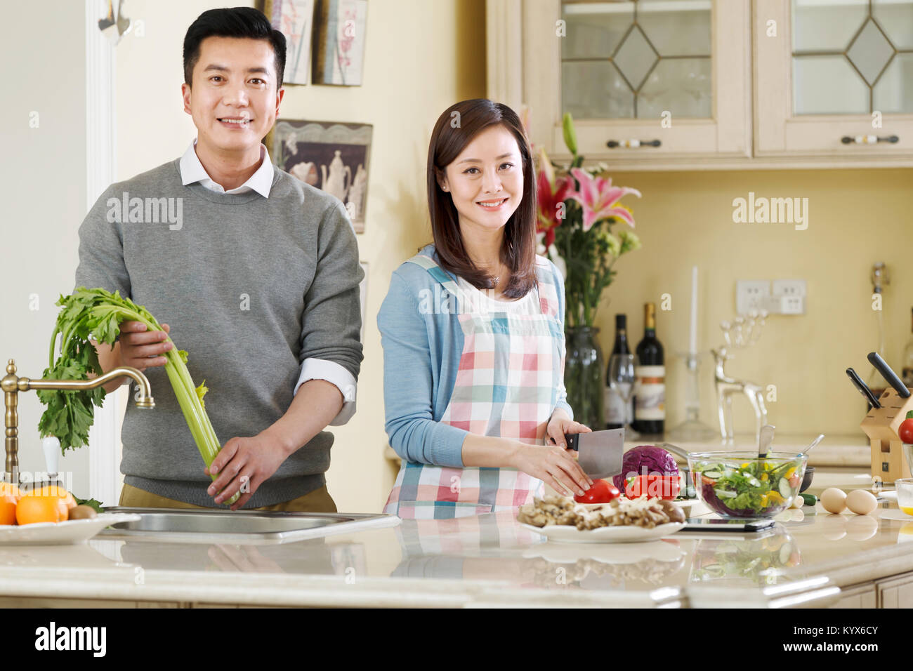 The middle-aged couple are in the kitchen Stock Photo