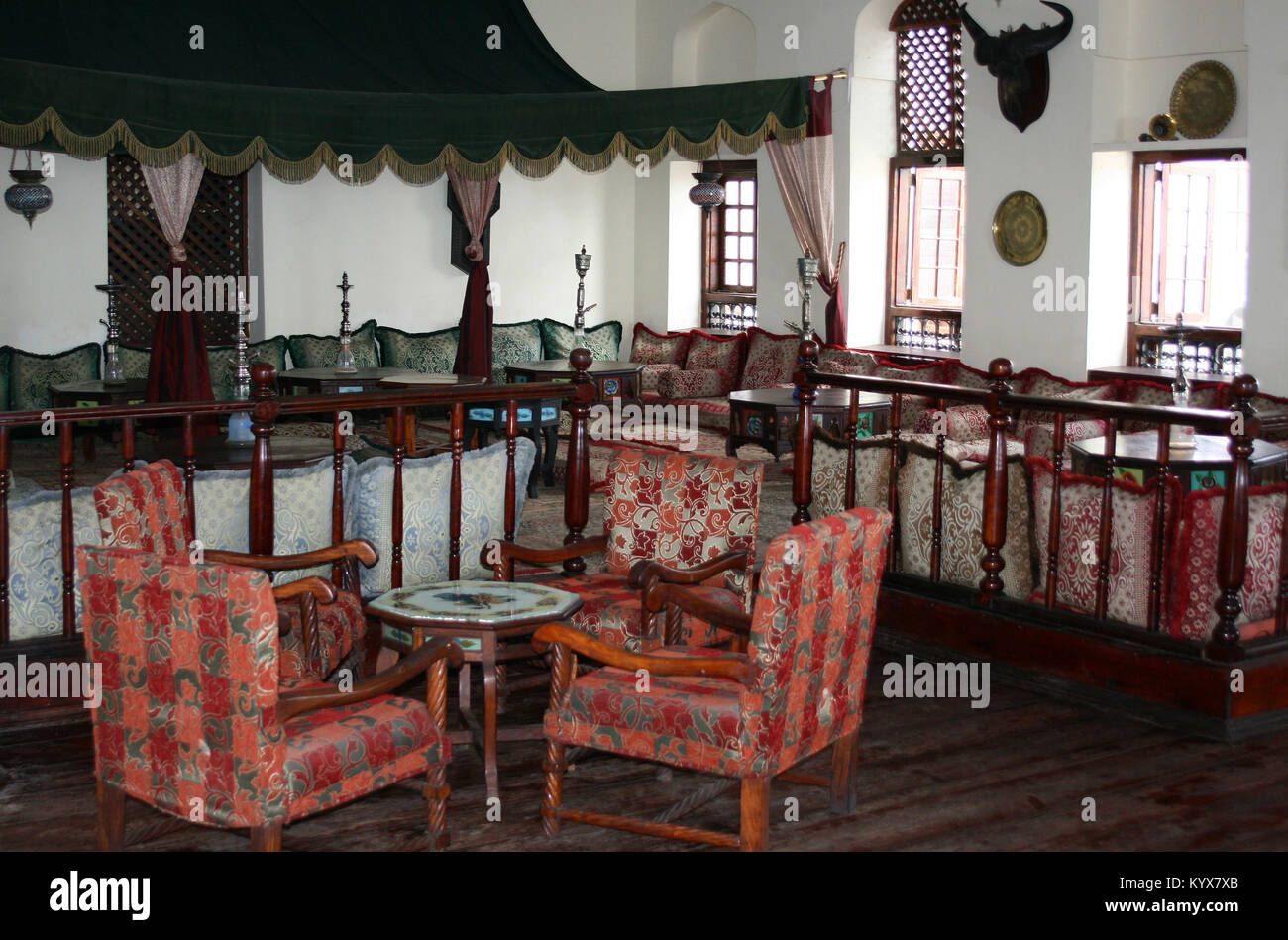 Hotel lounge with comfortable couches, armchairs and hookah pipes