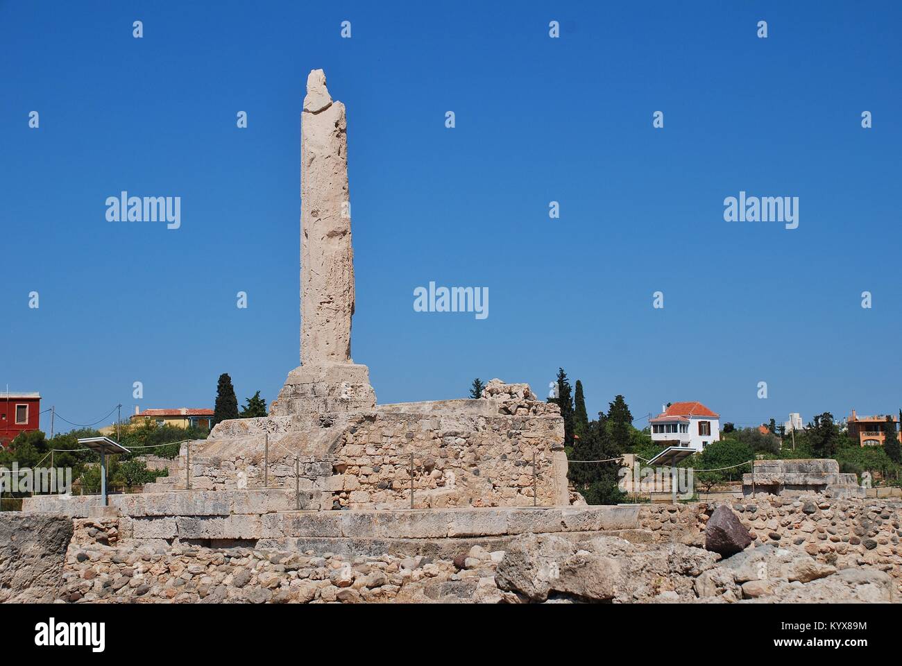 The remaining column of the Temple of Apollo at Aegina Town on the Greek island of Aegina. The ancient acropolis dates from circa 6th century BC. Stock Photo