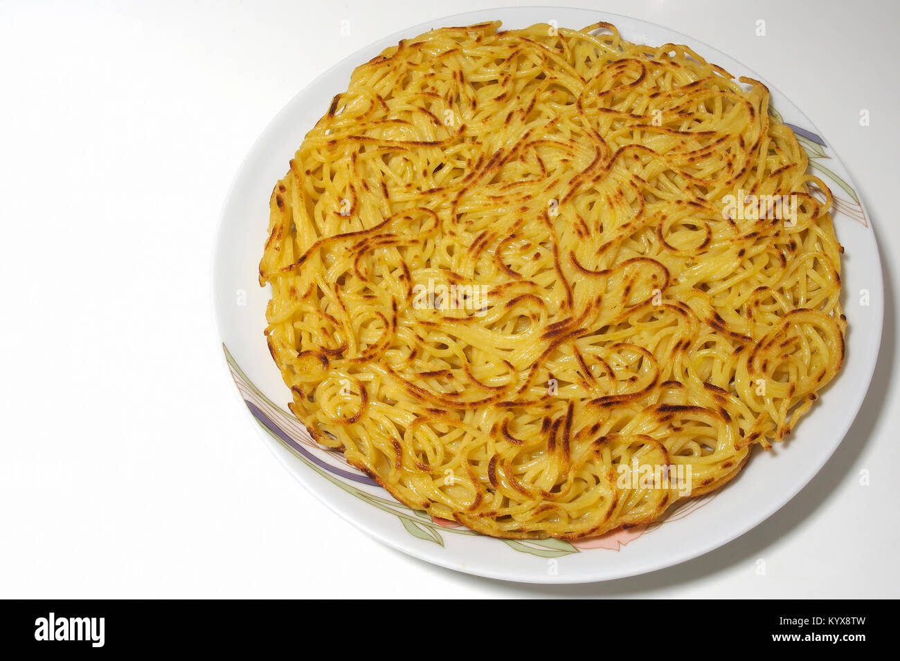 Vegan food. The famous Italian dish 'Frittata of spaghetti' in a vegan version replacing the eggs with a mixture of chickpea flour and water. Stock Photo