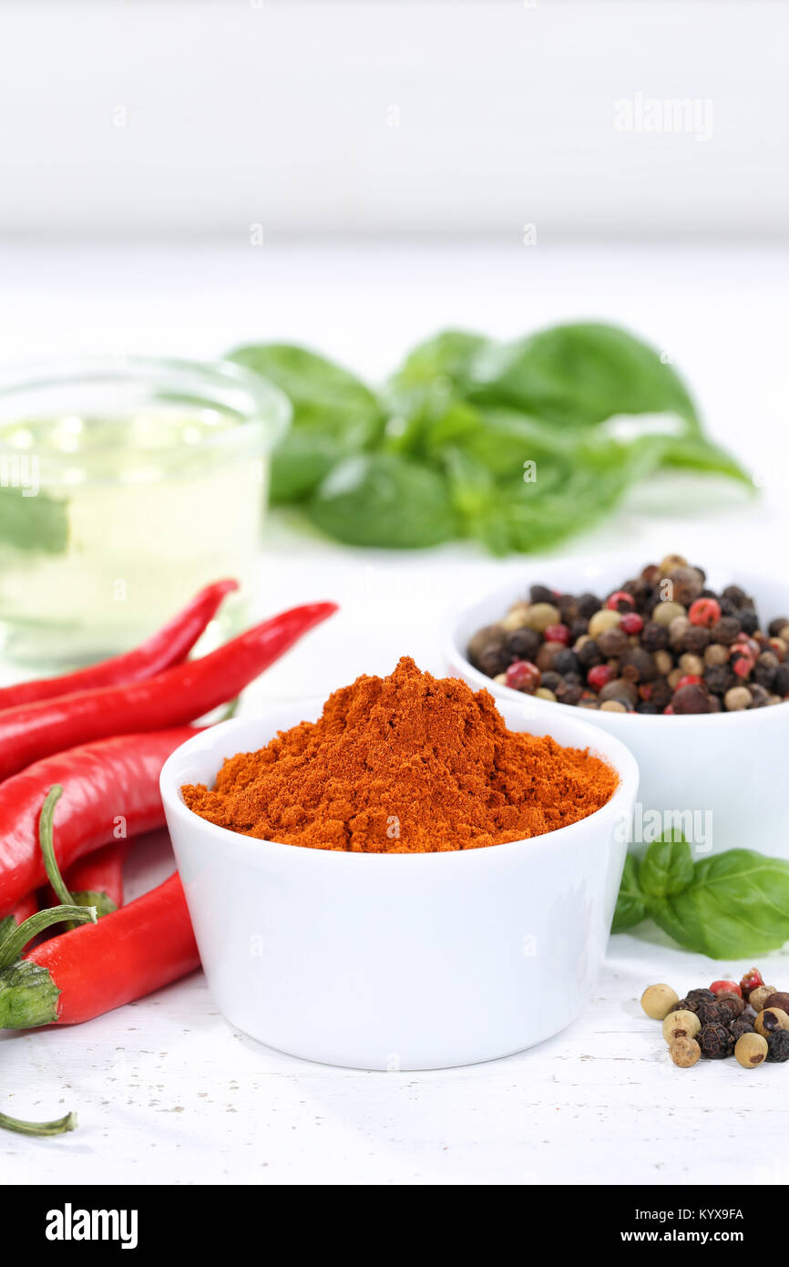 Spices cooking ingredients paprika powder spicy portrait format red hot chili peppers chilli spice Stock Photo
