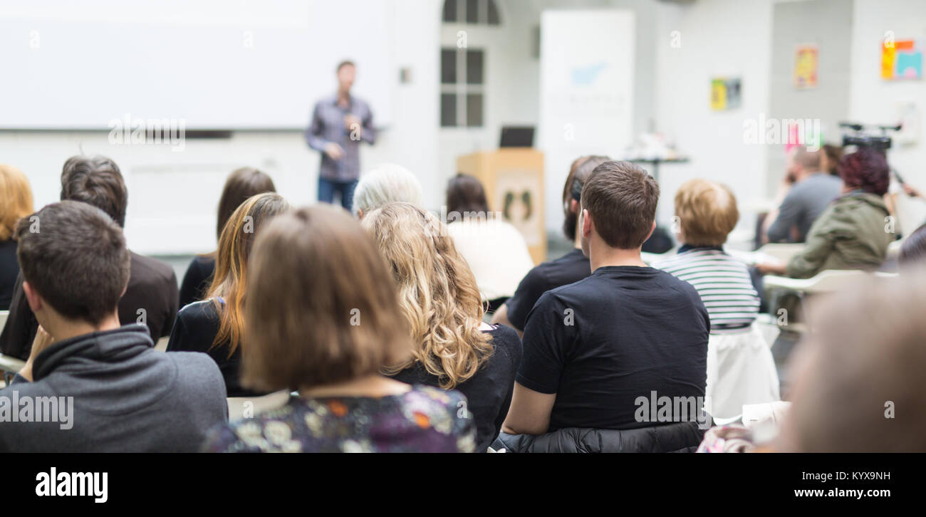 Man giving presentation in lecture hall at university. Stock Photo