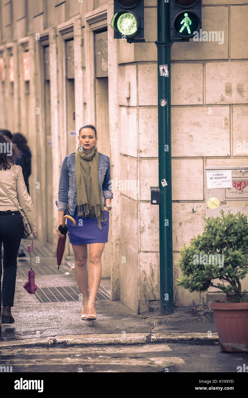 Woman with umbrella walking under the rain Stock Photo - Alamy