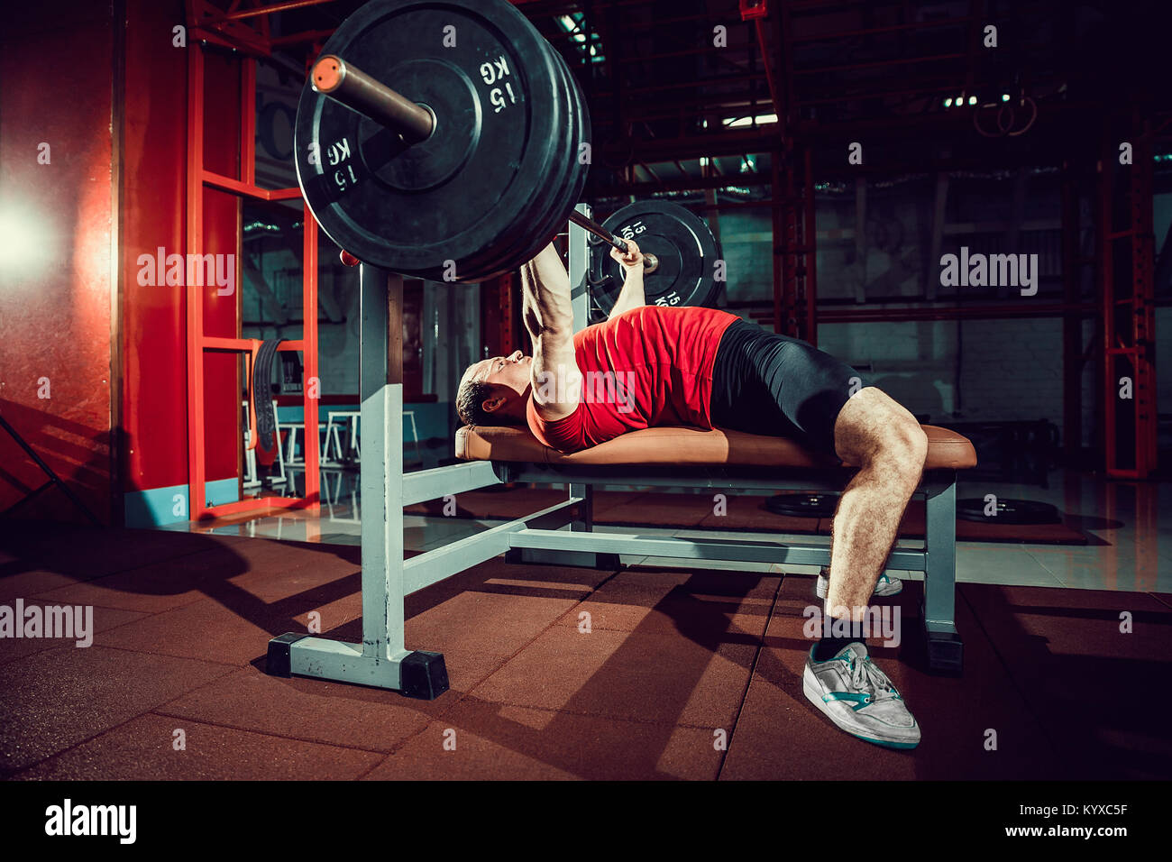 Man doing bench press workout in gym Stock Photo